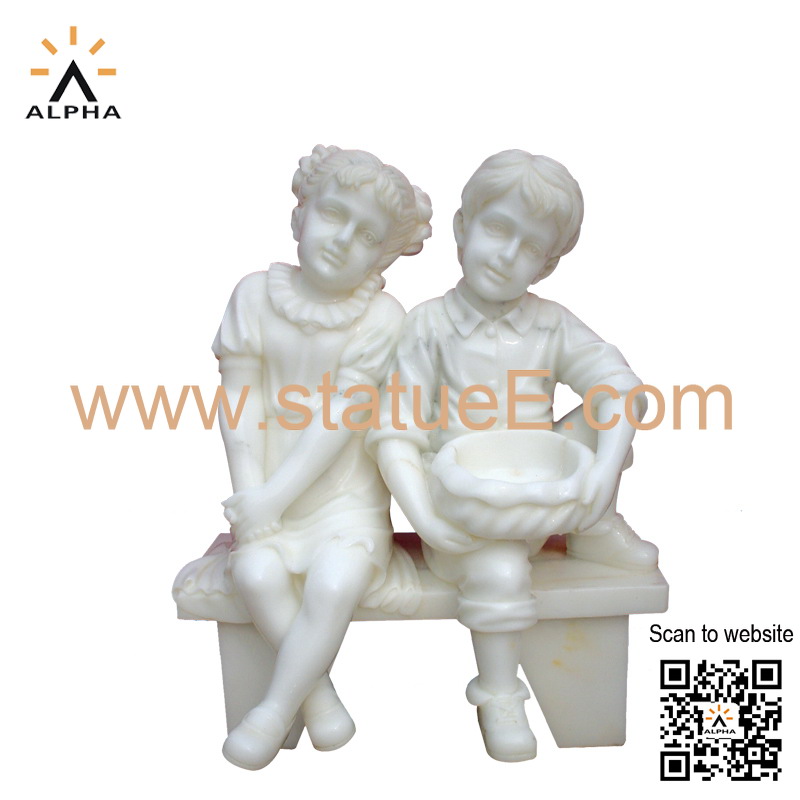 boy and girl on bench statue